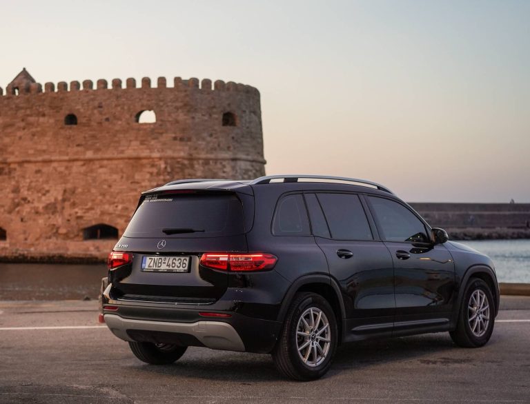 Heraklion Airport Taxi: Your Gateway to Comfort and Convenience. A luxury car in front of the heraklion castle of Koules.